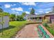 Backyard features a grassy lawn, stone patio, and a charming covered porch at 1830 Zang St, Golden, CO 80401