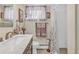 Bathroom featuring vanity with marble countertop, floral towels, and shower with white curtain at 1830 Zang St, Golden, CO 80401