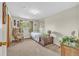 Cozy bedroom showcasing a vintage chair, natural light, and tasteful decor at 1830 Zang St, Golden, CO 80401