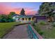 Charming home featuring a well-maintained yard, garden, and colorful sunset at 1830 Zang St, Golden, CO 80401