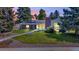 Charming single-Gathering home with a well-manicured lawn and beautiful landscaping at dusk at 1830 Zang St, Golden, CO 80401
