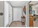 Inviting foyer with wood-look tile flooring, a decorative table, and view into another room at 1830 Zang St, Golden, CO 80401