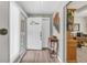 Inviting foyer with wood-look tile flooring, a decorative table, and view into another room at 1830 Zang St, Golden, CO 80401
