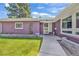 Close-up of the house's front entrance with a well-kept lawn at 1830 Zang St, Golden, CO 80401