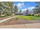 Landscaped front yard with decorative rocks, healthy lawn, and a paved walkway leading to the home at 1830 Zang St, Golden, CO 80401