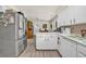 Well-equipped kitchen with stainless steel refrigerator and connection to a large dining area at 1830 Zang St, Golden, CO 80401