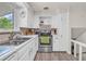 Efficient kitchen with stainless steel appliances, white cabinets, and cozy breakfast nook at 1830 Zang St, Golden, CO 80401