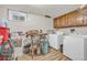 Laundry room with front load washer/dryer, utility sink, and wood cabinets at 1830 Zang St, Golden, CO 80401