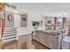 Cozy living room featuring hardwood floors, a stone fireplace, and abundant natural light at 1830 Zang St, Golden, CO 80401