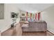 Bright living room features hardwood floors, a stone fireplace, large windows, and comfortable sofa at 1830 Zang St, Golden, CO 80401