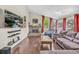 Bright living room features hardwood floors, a stone fireplace, large windows, and comfortable sofa at 1830 Zang St, Golden, CO 80401