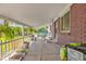Exterior shot of a home's covered porch featuring plants and furniture at 1830 Zang St, Golden, CO 80401