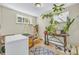 Bright room with windows, house plants, vintage table, and decor at 1830 Zang St, Golden, CO 80401