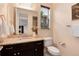 Cozy powder room featuring a granite vanity top and a window providing natural light at 10783 Skydance Dr, Highlands Ranch, CO 80126