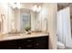 Bathroom featuring dual sinks, granite countertops, and a shower/tub combo at 10783 Skydance Dr, Highlands Ranch, CO 80126