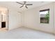 Inviting bedroom with ample natural light, a ceiling fan, and attached bathroom at 10783 Skydance Dr, Highlands Ranch, CO 80126