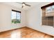 Bedroom with hardwood floors, ceiling fan and bright windows at 10783 Skydance Dr, Highlands Ranch, CO 80126
