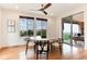 Dining room with large windows, natural light, a decorative ceiling fan, and access to an outdoor patio at 10783 Skydance Dr, Highlands Ranch, CO 80126