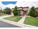 Beautiful stucco home features a tile roof, stone accents, lush lawn, and a spacious driveway at 10783 Skydance Dr, Highlands Ranch, CO 80126
