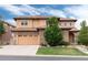 Stunning two-story home features a tile roof, stone accents, a well-manicured lawn, and a three-car garage at 10783 Skydance Dr, Highlands Ranch, CO 80126