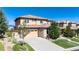 Elegant two-story home featuring a tile roof, stone accents, and an attached three-car garage at 10783 Skydance Dr, Highlands Ranch, CO 80126