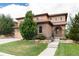 Charming two-story home with stucco and stone exterior, lush lawn, and inviting entrance at 10783 Skydance Dr, Highlands Ranch, CO 80126
