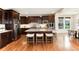 Stylish kitchen with dark wood cabinets, stainless steel appliances, granite counters, and a central island with seating at 10783 Skydance Dr, Highlands Ranch, CO 80126