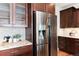 Modern kitchen with stainless steel refrigerator and mosaic tile backsplash at 10783 Skydance Dr, Highlands Ranch, CO 80126