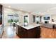 Bright kitchen with granite countertops, stainless appliances, and an island that connects to the inviting living room space at 10783 Skydance Dr, Highlands Ranch, CO 80126