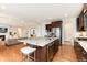 Open kitchen boasts granite counters, stainless appliances, island with seating, and seamless flow into the living area at 10783 Skydance Dr, Highlands Ranch, CO 80126