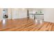 Bright open-concept living area boasts hardwood floors, fresh paint, and stylish staircase at 10783 Skydance Dr, Highlands Ranch, CO 80126