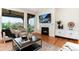 Comfortable living room with a fireplace, TV, elegant decor, and hardwood flooring provides the perfect space for relaxation at 10783 Skydance Dr, Highlands Ranch, CO 80126