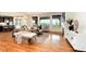 Inviting living room with large windows, hardwood floors, and a cozy fireplace creates a relaxing space at 10783 Skydance Dr, Highlands Ranch, CO 80126
