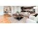 Open living space with hardwood floors seamlessly connects to the dining and kitchen areas, perfect for entertaining at 10783 Skydance Dr, Highlands Ranch, CO 80126