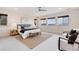 Spacious primary bedroom boasts bright windows, neutral tones, and stylish decor at 10783 Skydance Dr, Highlands Ranch, CO 80126