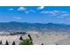 Breathtaking mountain views from this home's roofline, surrounded by rolling hills and beautiful blue skies at 10783 Skydance Dr, Highlands Ranch, CO 80126