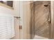 Close up of tiled shower with glass door, a sleek shower head, and modern hardware at 10783 Skydance Dr, Highlands Ranch, CO 80126