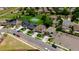 Aerial view of the neighborhood featuring sidewalks, green spaces, and a basketball court at 502 Ledge St, Brighton, CO 80603