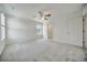 Main bedroom features ceiling fan, carpeted floors, window and ensuite bathroom at 502 Ledge St, Brighton, CO 80603