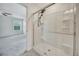 Clean bathroom shower with glass door, white tiles and shower head at 502 Ledge St, Brighton, CO 80603