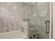 Luxurious marble bathroom featuring a soaking tub and glass-enclosed shower at 1688 Pine Valley Rd, Evergreen, CO 80439