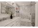 Elegant bathroom with marble walls, double vanity, and a built-in bathtub at 1688 Pine Valley Rd, Evergreen, CO 80439