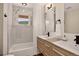 Modern bathroom with a marble shower, double sinks, wood cabinets, and updated fixtures at 1688 Pine Valley Rd, Evergreen, CO 80439
