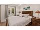 Cozy bedroom with wooden furniture, soft lighting, and a large window with natural view at 1688 Pine Valley Rd, Evergreen, CO 80439