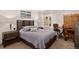 Relaxing bedroom featuring warm wooden furniture, soft decor, and a scenic outdoor view at 1688 Pine Valley Rd, Evergreen, CO 80439