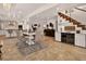 Open concept, bright, dining area with adjacent kitchen, stylish table/chairs, and modern stairs at 1688 Pine Valley Rd, Evergreen, CO 80439