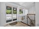 Bright foyer with sliding glass doors, modern railing, and a built-in display niche at 1688 Pine Valley Rd, Evergreen, CO 80439