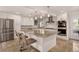 Modern white kitchen featuring a large island, stainless steel appliances, and sleek countertops at 1688 Pine Valley Rd, Evergreen, CO 80439