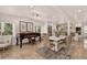 Bright living room showcasing a piano, dining area, and open kitchen with lots of natural light at 1688 Pine Valley Rd, Evergreen, CO 80439