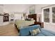 Main bedroom featuring a fireplace, vaulted ceiling, large windows, and stylish decor at 1688 Pine Valley Rd, Evergreen, CO 80439